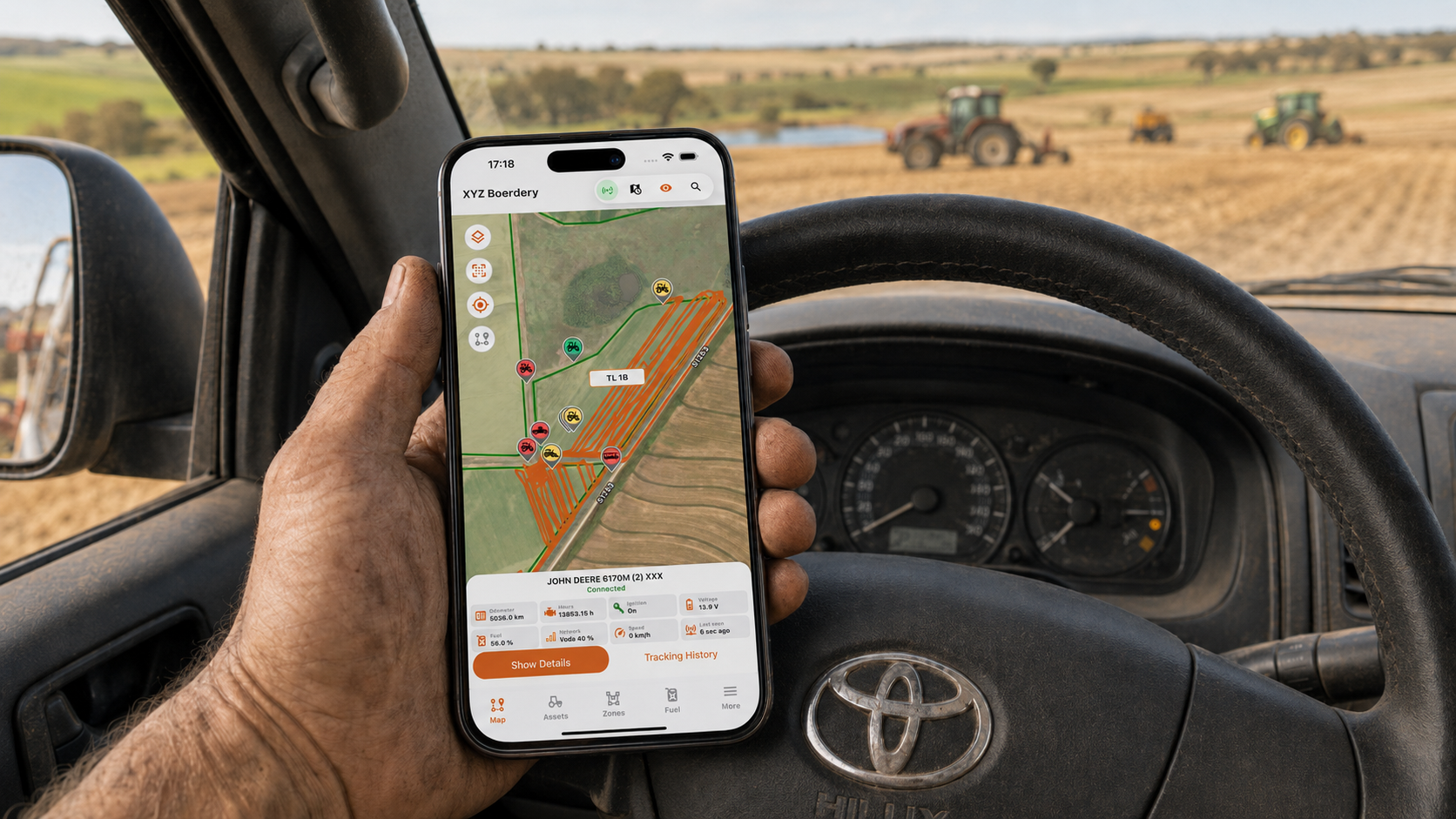 Mobile phone showing Agri-Fleet Systems vehicle tracking while inside a farm vehicle